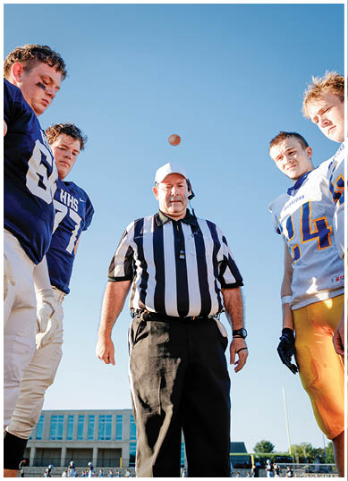 A football player wearing a blue and red jersey. Description generated by AI