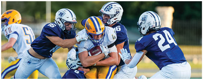 A football player is sliding on the ground. Description generated by AI
