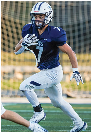 A football player running on the field. Description generated by AI