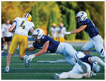 A football player running on the field. Description generated by AI