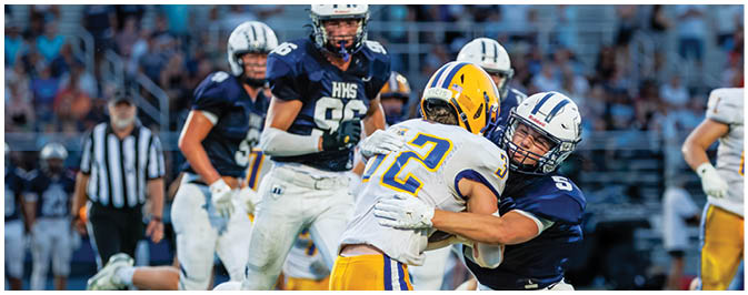 A football player is sliding on the ground. Description generated by AI