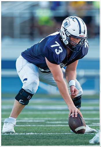 A football player running on the field. Description generated by AI