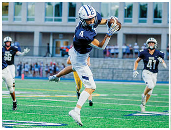 A football player running on the field. Description generated by AI