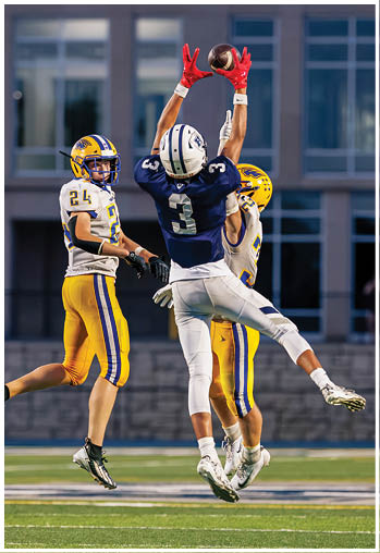 A football player running on the field. Description generated by AI