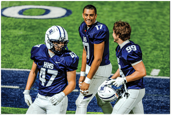 A group of football players wearing black and white uniforms. Description generated by AI