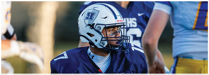 A group of football players on a field. Description generated by AI