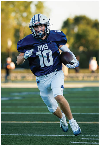 A football player running on the field. Description generated by AI