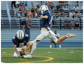 A football player running on the field. Description generated by AI