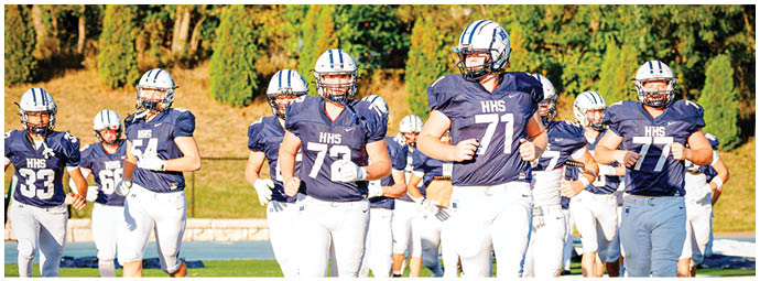 A football player wearing a blue and white uniform. Description generated by AI