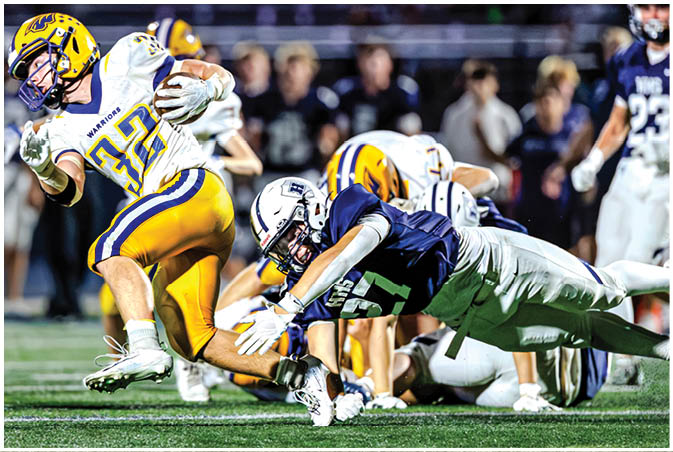 A group of football players wearing black and white uniforms. Description generated by AI