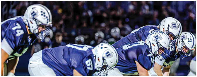 A football player is sliding on the ground. Description generated by AI