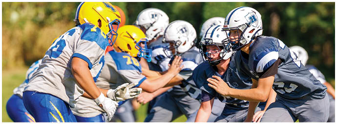 A football player wearing a blue and white uniform. Description generated by AI