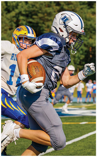 A football player catching a ball. Description generated by AI