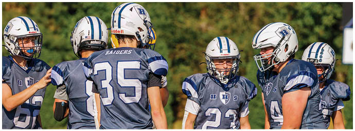 A football player wearing a blue and white uniform. Description generated by AI