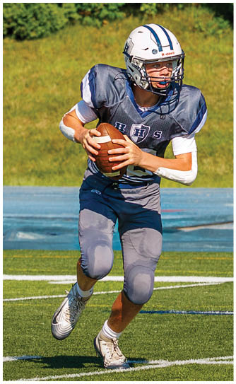 A football player catching a ball. Description generated by AI