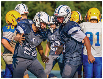 A group of football players on a field. Description generated by AI
