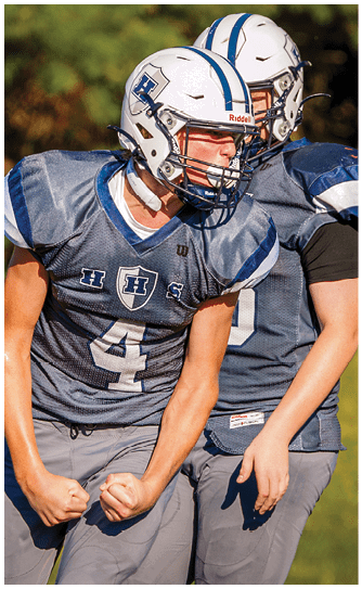 A football player catching a ball. Description generated by AI