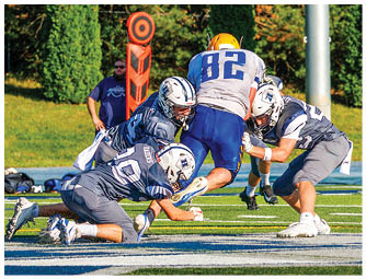 A group of football players on a field. Description generated by AI