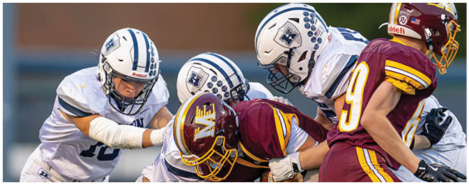 A football player is sliding on the ground. Description generated by AI