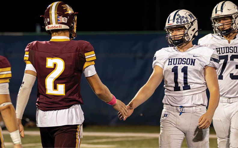 A football player wearing a blue and white jersey with the number 11 on it. Description generated by AI