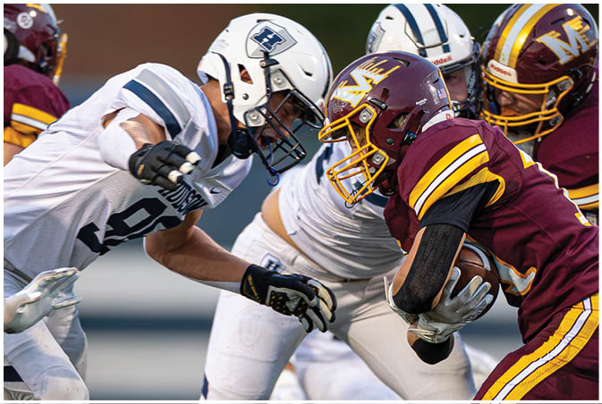 A group of football players wearing black and white uniforms. Description generated by AI