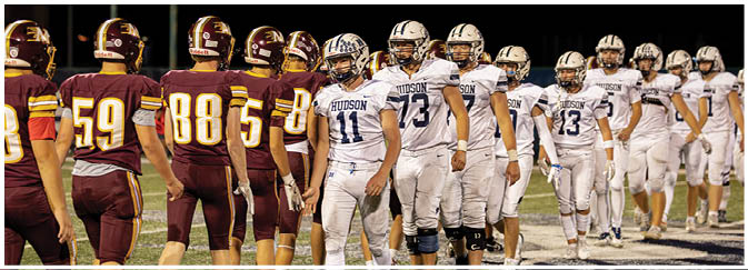 A group of football players on a field. Description generated by AI