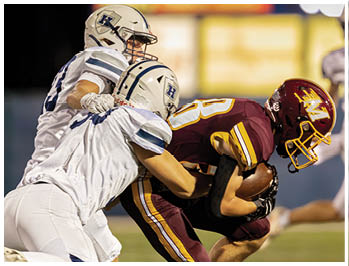 A football player running on the field. Description generated by AI