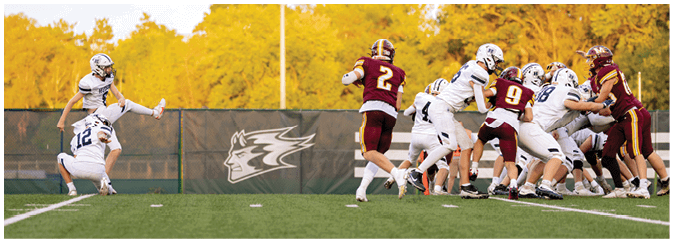 A group of football players on a field. Description generated by AI