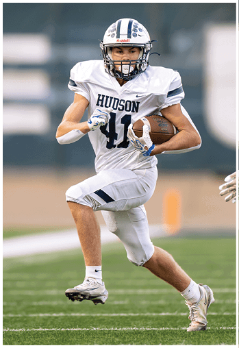 A football player running on the field. Description generated by AI