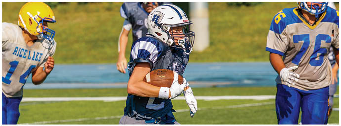 A football player wearing a blue and white uniform. Description generated by AI