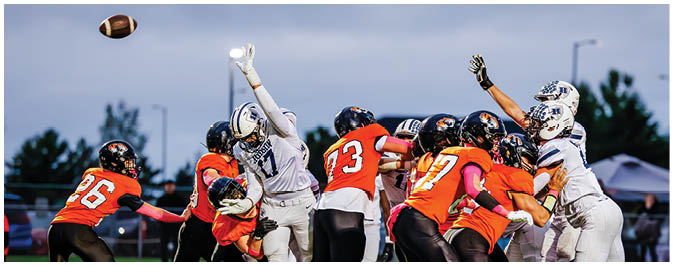A football player is sliding on the ground. Description generated by AI
