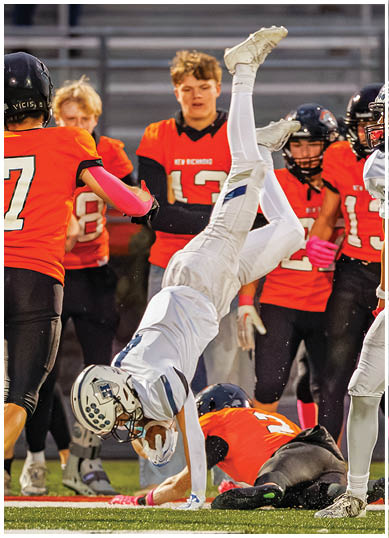 A football player wearing a blue and red jersey. Description generated by AI