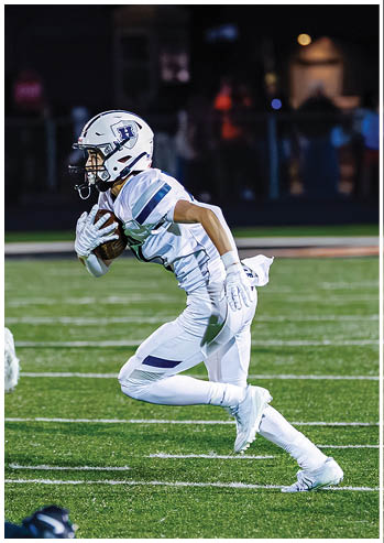 A football player running on the field. Description generated by AI