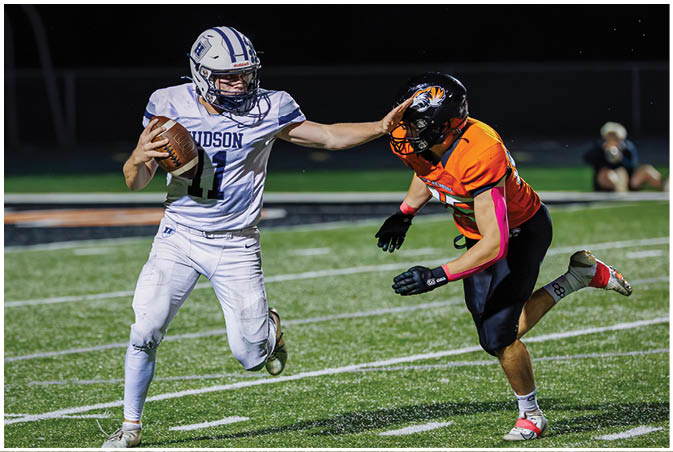 A group of football players wearing black and white uniforms. Description generated by AI