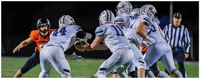 A football player is sliding on the ground. Description generated by AI
