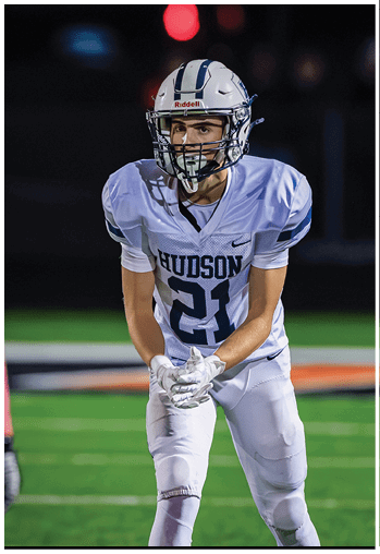 A football player running on the field. Description generated by AI