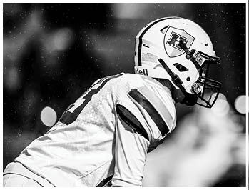 A football player running on the field. Description generated by AI