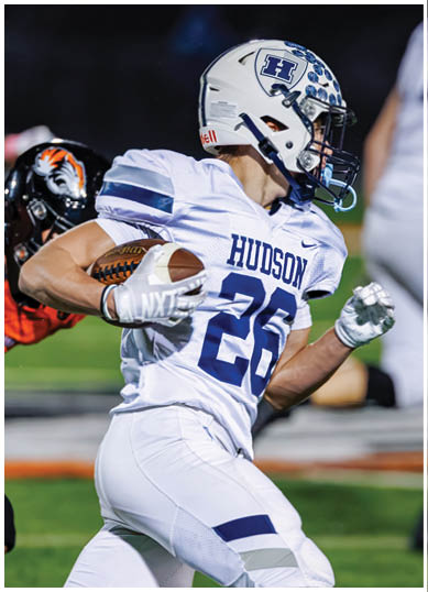 A football player wearing a blue and red jersey. Description generated by AI