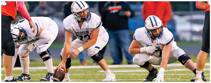 A football player is sliding on the ground. Description generated by AI