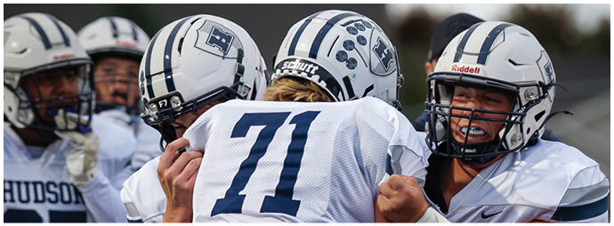 A football player wearing a blue and white uniform. Description generated by AI