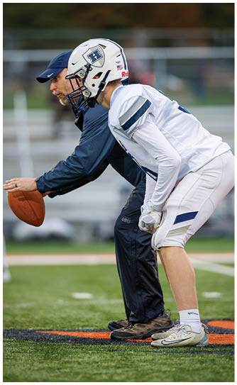 A football player catching a ball. Description generated by AI