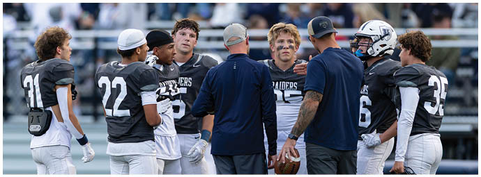A football player wearing a blue and white uniform. Description generated by AI