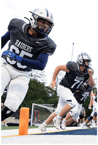 A football game is being played on a field. Description generated by AI