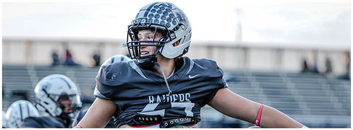 A football player wearing a blue and white uniform. Description generated by AI