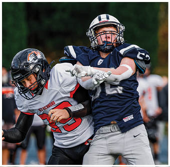 Three football players in blue and white uniforms running on a field. Description generated by AI
