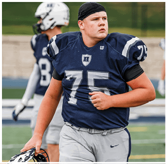 Three football players in blue and white uniforms running on a field. Description generated by AI