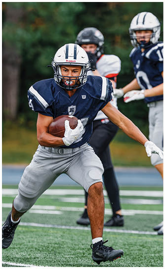 A football player catching a ball. Description generated by AI