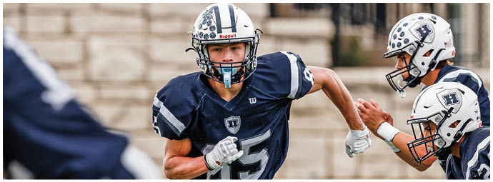A football player wearing a blue and white uniform. Description generated by AI