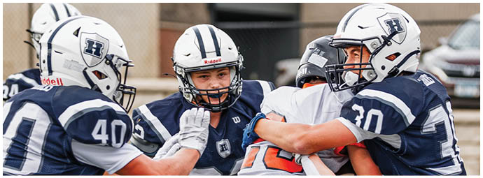 A football player wearing a blue and white uniform. Description generated by AI