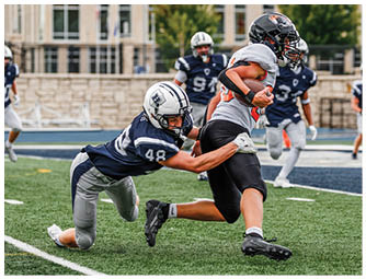 A group of football players on a field. Description generated by AI
